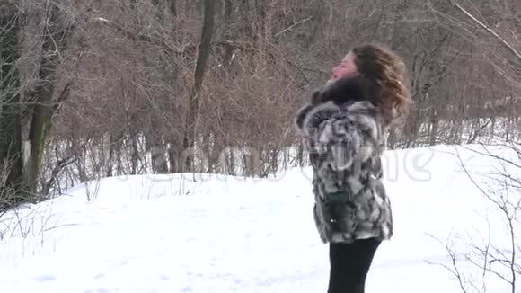 穿着毛皮外套头发松松的女孩在等待她最喜欢的冬天视频的预览图