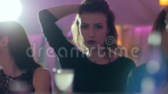 喝醉的女孩在酒吧附近慢动作跳舞背景模糊视频的预览图