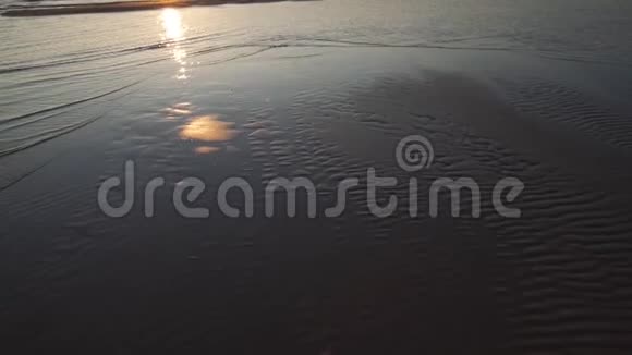 深红的日落晴朗的天空和镜子像水中的倒影带状的沙子和波浪拉脱维亚图亚4月13日视频的预览图