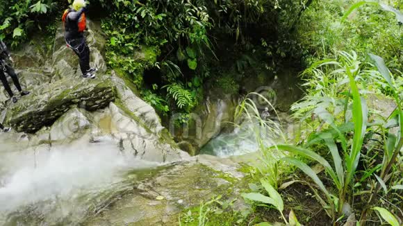 厄瓜多尔雨林峡谷中活跃的女士跳入瀑布视频的预览图
