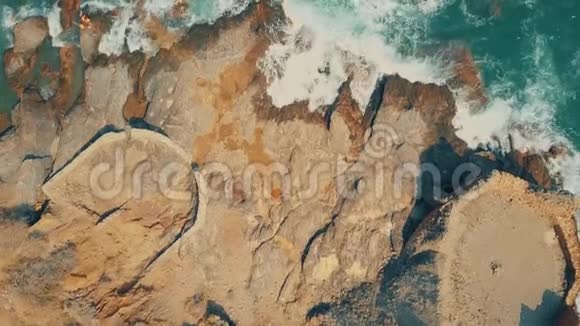 空中自上而下的海浪和岩石上的古堡废墟视频的预览图