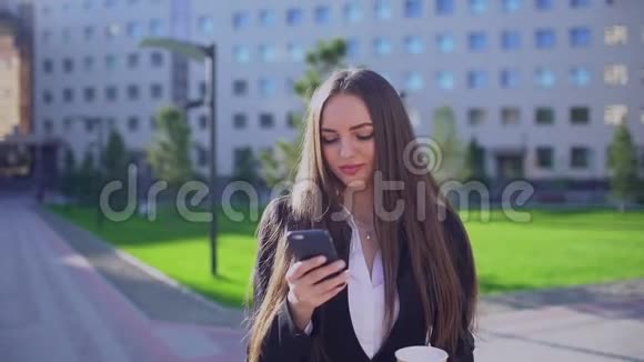 年轻的职业女商人或女学生走路和使用手机智能手机发短信的妇女视频的预览图