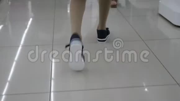孩子穿着运动鞋在精品店里散步购物视频的预览图