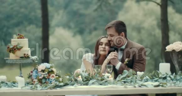一对可爱的年轻情侣穿着老式老式布衣在雾蒙蒙的树林里轻轻地亲吻和牵手视频的预览图