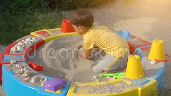 在沙箱里玩沙子的男孩视频的预览图