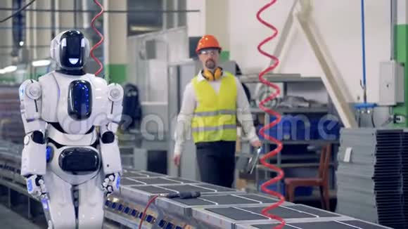 工程师控制机器人在工厂的传送带上工作4K视频的预览图
