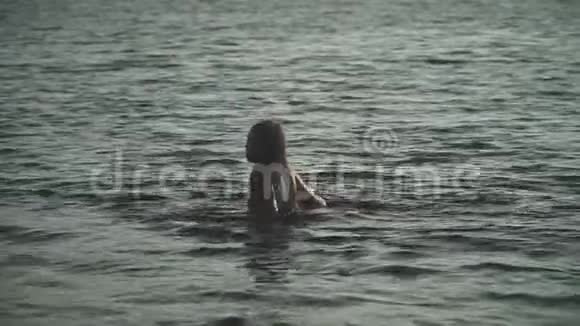 美丽的年轻女孩长发从河里出来视频的预览图