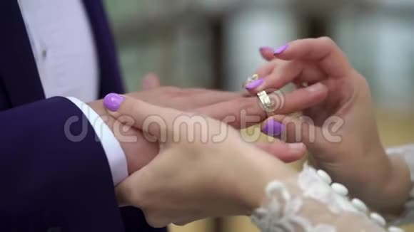 新娘在婚礼上给新郎手指戴上戒指视频的预览图