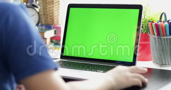 多莉在肩膀上看着小男孩在笔记本电脑上看正在使用的技术绿色屏幕Chroma钥匙视频的预览图