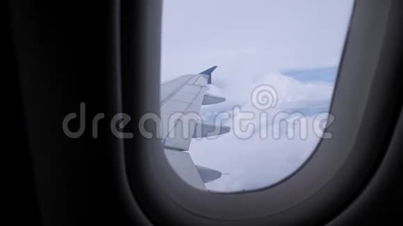 从机翼天空和云层上的飞机窗口观看视频的预览图
