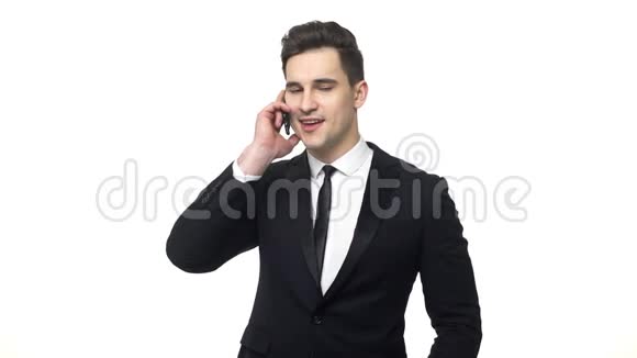 成功的商人在手机上交谈和微笑一位年轻英俊的商人在手机上聊天视频的预览图