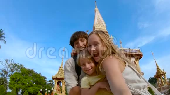 泰国普吉岛的一座佛教寺庙前一位家庭主妇正在自拍的慢镜头视频的预览图
