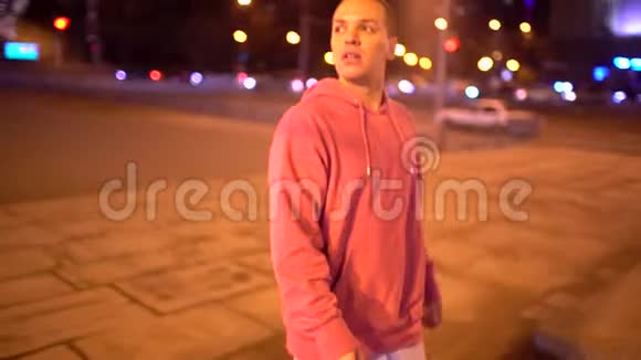 那个人拿着彩色灯笼走在夜城街的小巷里他的车背景慢动作青年视频的预览图