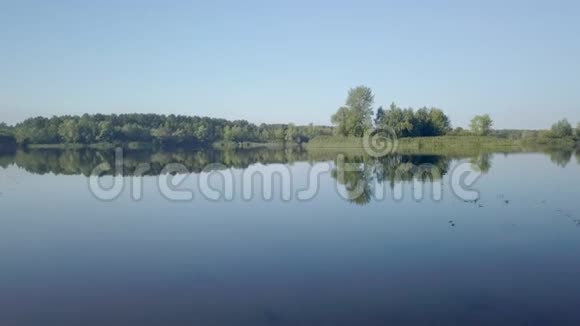 阳光明媚照相机在平静光滑的湖面上飞过视频的预览图