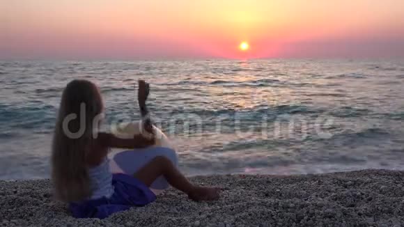 4孩子在日落的沙滩上玩耍快乐的女孩在海水中扔球视频的预览图