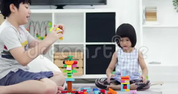 亚洲兄妹一起玩塑料块在家带着笑脸视频的预览图