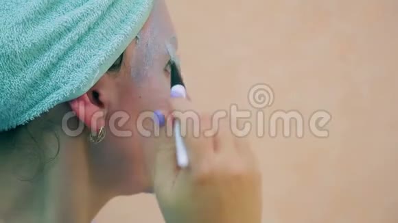 女人的脸头上有毛巾皮肤面具上有刷子概况视频的预览图