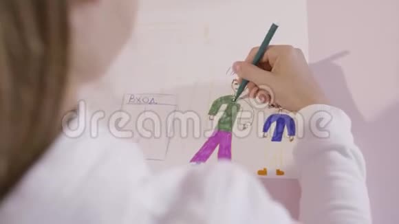 幼儿在一张纸上画一支铅笔行动一个年轻的女孩画在一张纸上给妈妈的礼物视频的预览图
