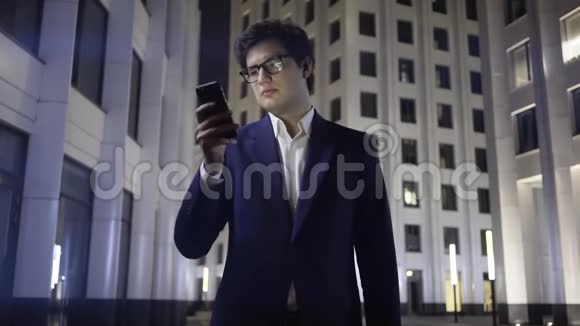 一个严肃的年轻商人在夜城上网视频的预览图