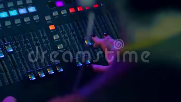 女性手后面的混合控制台混合轨道迪斯科在彩色照明视频的预览图
