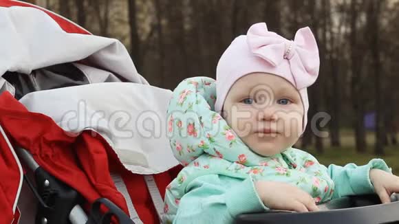 坐在婴儿车里的小女孩呱呱叫视频的预览图
