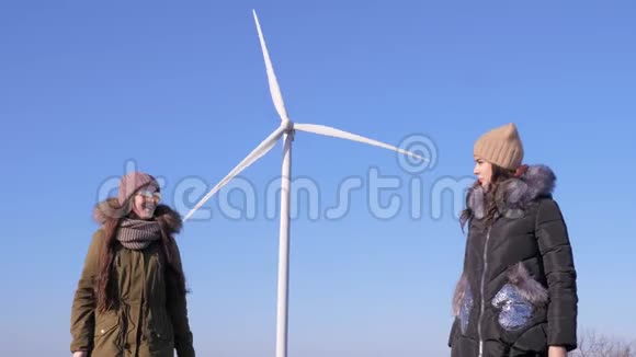 风车转动快乐的女朋友热情地指着风力涡轮机视频的预览图