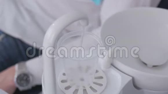 牙科设备水倒入一次性塑料碗中患者取杯冲洗口腔视频的预览图