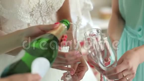 在一个单身派对上女孩的特写镜头把香槟倒进玻璃杯里视频的预览图