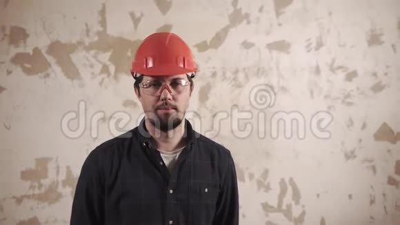 一位管家的肖像一位工人站在一堵修过的墙的背景上视频的预览图