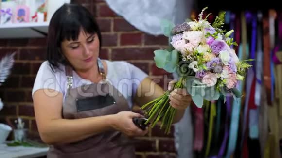 专业花艺师在花艺设计工作室用剪刀剪花茎视频的预览图
