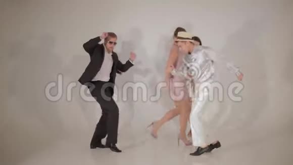 三个漂亮的女人和三个可爱的跨种族男人积极地在白色工作室跳舞视频的预览图