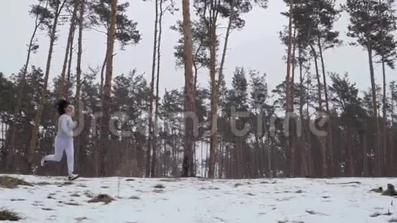 年轻女孩在森林里慢跑时跳过树桩视频的预览图