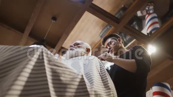 理发师为资深男士做时尚发型视频的预览图