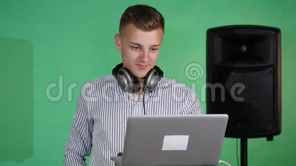 DJ看着笔记本电脑跳舞视频的预览图