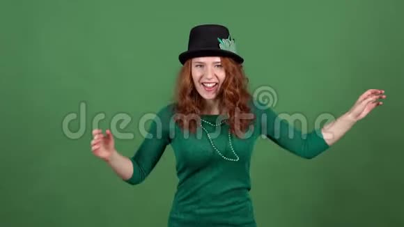 年轻女子庆祝圣帕特里克节绿色的墙上跳舞欢快视频的预览图