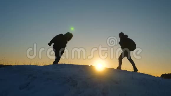 登山者在雪山顶上相遇享受他们的成功举起手快乐地跳跃男性游客视频的预览图