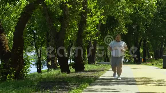大腹便便的男性在公园里奔跑充满动力和健康的生活方式视频的预览图
