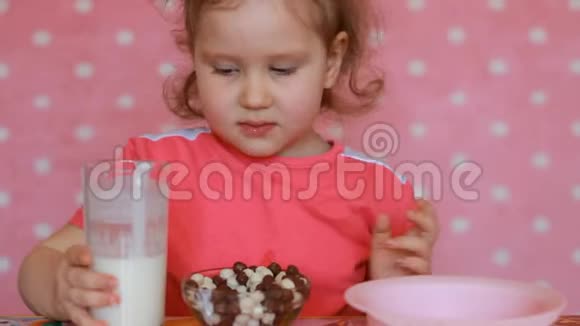 一个孩子用酸奶为自己准备早餐小女孩吃东西视频的预览图