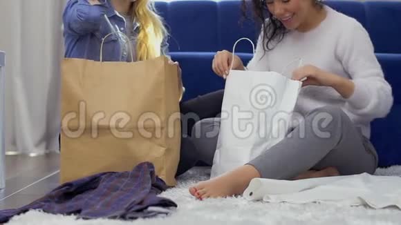 3年轻女孩买完衣服给她的朋友看视频的预览图
