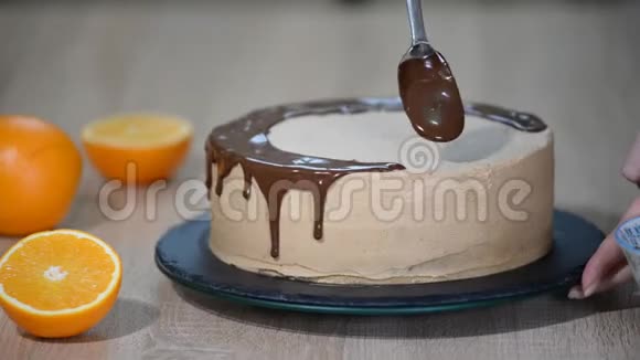 厨师挤压奶油巧克力蛋糕上的糖霜白色蛋糕上覆盖着巧克力和奶油巧克力蛋糕装饰视频的预览图