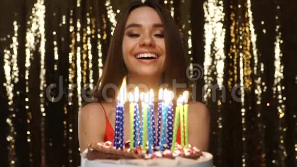 生日派对快乐的女人在蛋糕画像上吹蜡烛视频的预览图