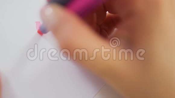 女性在纸上画粉红色的记号视频的预览图