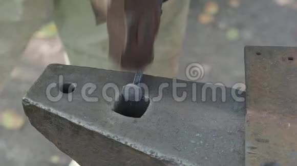 村里的铁匠在铁砧上锻造铁钉视频的预览图