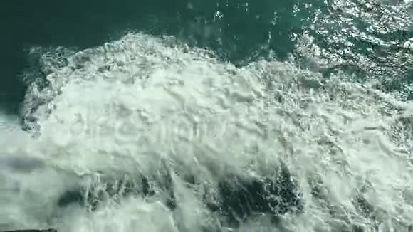 强大的波浪从快速移动的船上拉出在阳光明媚的日子里一股巨大的深蓝色的水流慢动作1920x1080视频的预览图
