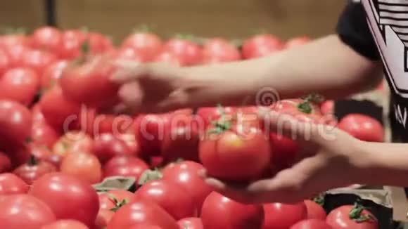 女的手在超市里挑选西红柿视频的预览图
