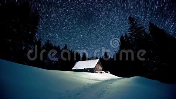 时间流逝在冬天的森林里星星在木屋上盘旋视频的预览图