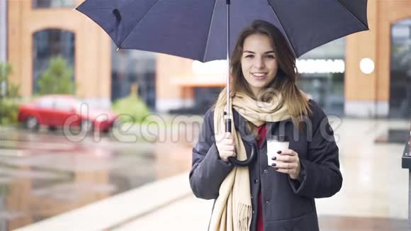 开朗的女人在伞下喝咖啡视频的预览图