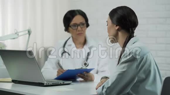 医生在办公室听病人说女人抱怨疾病头痛视频的预览图
