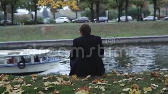 人坐在运河的岸边视频的预览图