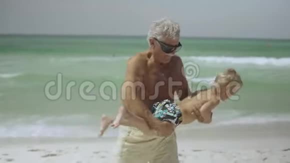 爷爷和他的孙子在海滩上玩得很开心视频的预览图